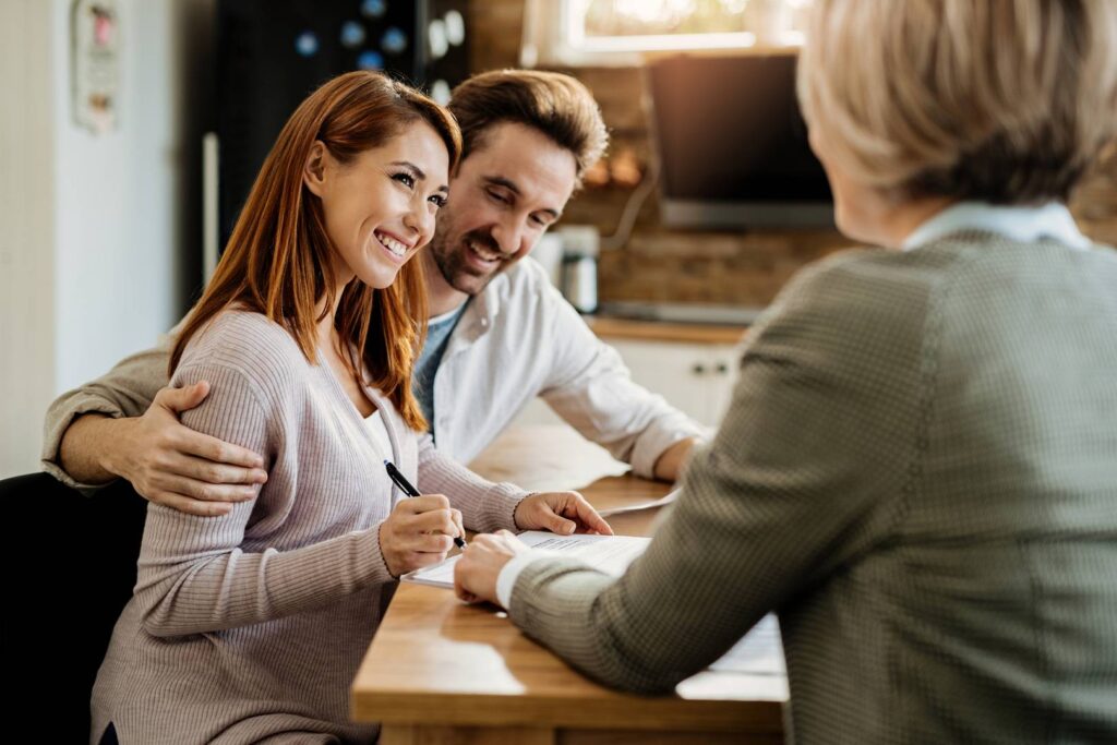 young-happy-woman-her-husband-signing-agreement-with-insurance-agent-meeting_wp